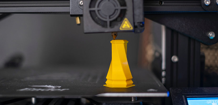 3D printer printing a yellow object